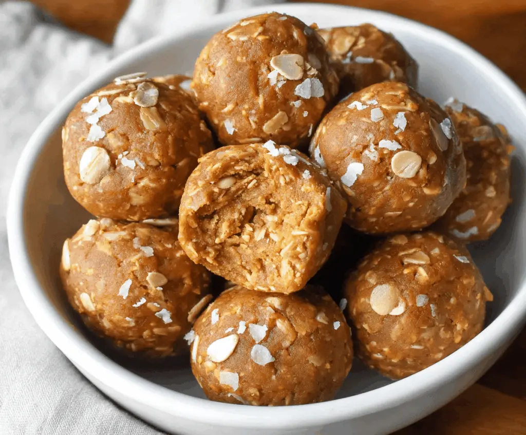 Delicious homemade almond butter pumpkin protein balls on a white plate, perfect for healthy snacking and packed with protein and autumn flavors.