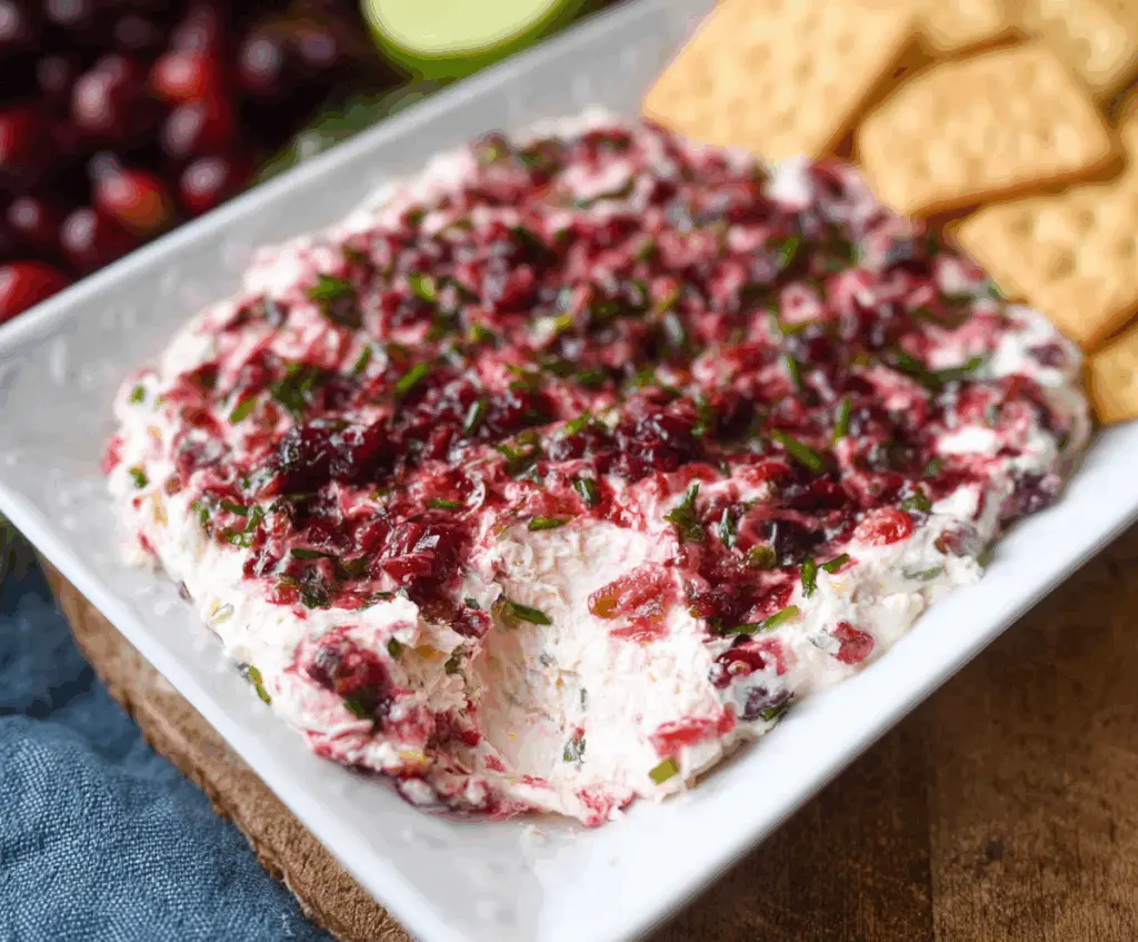 Creamy Cranberry Jalapeño Cream Cheese Dip with fresh cranberries and sliced jalapeños for snacking.