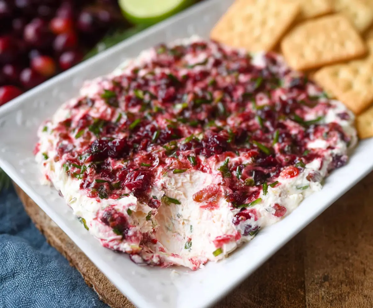 Creamy Cranberry Jalapeño Cream Cheese Dip with fresh cranberries and sliced jalapeños for snacking.