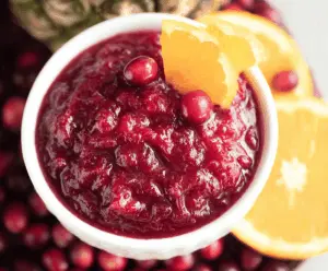 Vibrant Pineapple Cranberry Orange Sauce served in a bowl, highlighting its bright colors and fresh fruit ingredients.