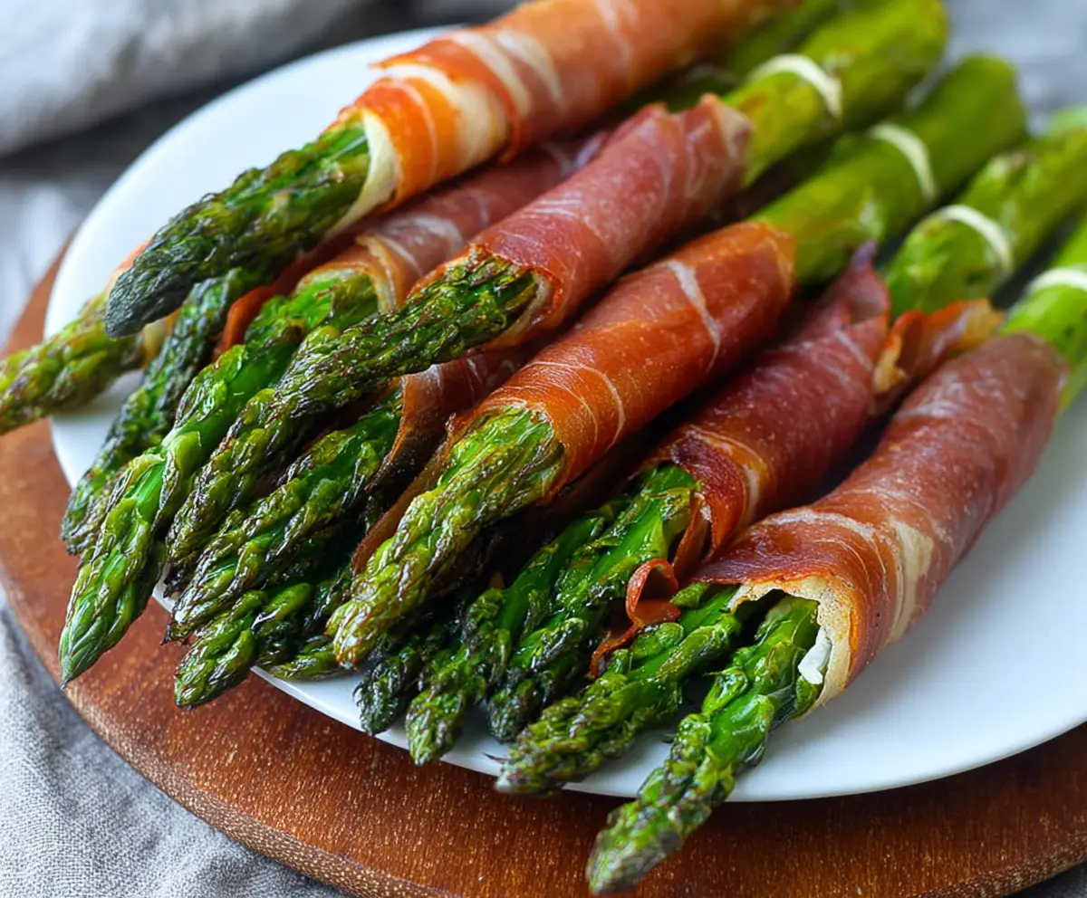 Delicious prosciutto-wrapped asparagus spears on a plate, perfect appetizer or party snack.