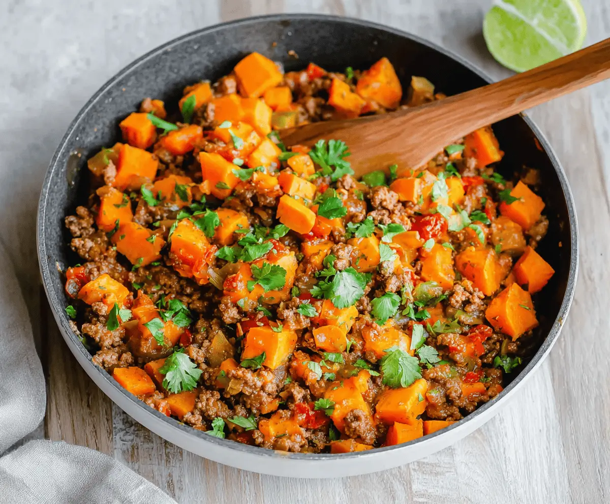 Delicious sweet potato and ground beef skillet with fresh herbs and vegetables.