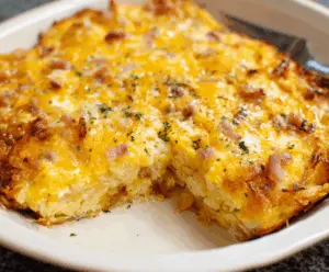 Delicious Cheesy Hashbrown Egg Casserole with melted cheese and crispy hashbrowns served in a baking dish.