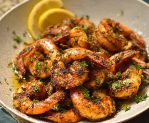 Delicious pan-fried shrimp with golden crispy coating served on a plate.