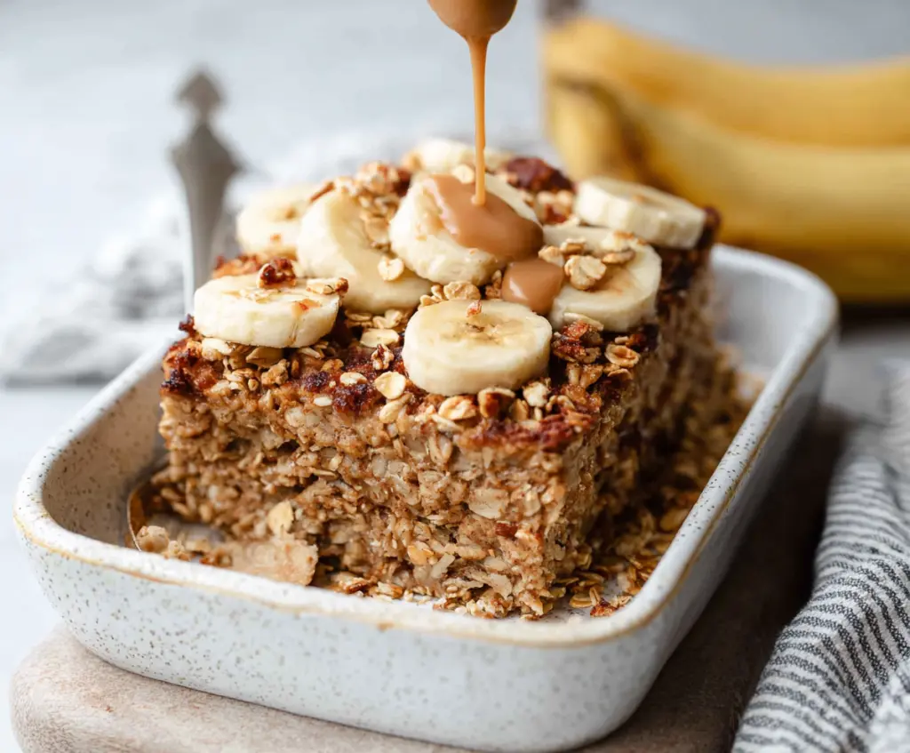 Delicious Banana Bread Baked Oatmeal served in a baking dish with ripe bananas and a golden crust.