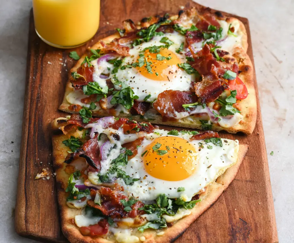 Savory breakfast flatbread topped with eggs, cheese, and fresh herbs on a rustic plate.