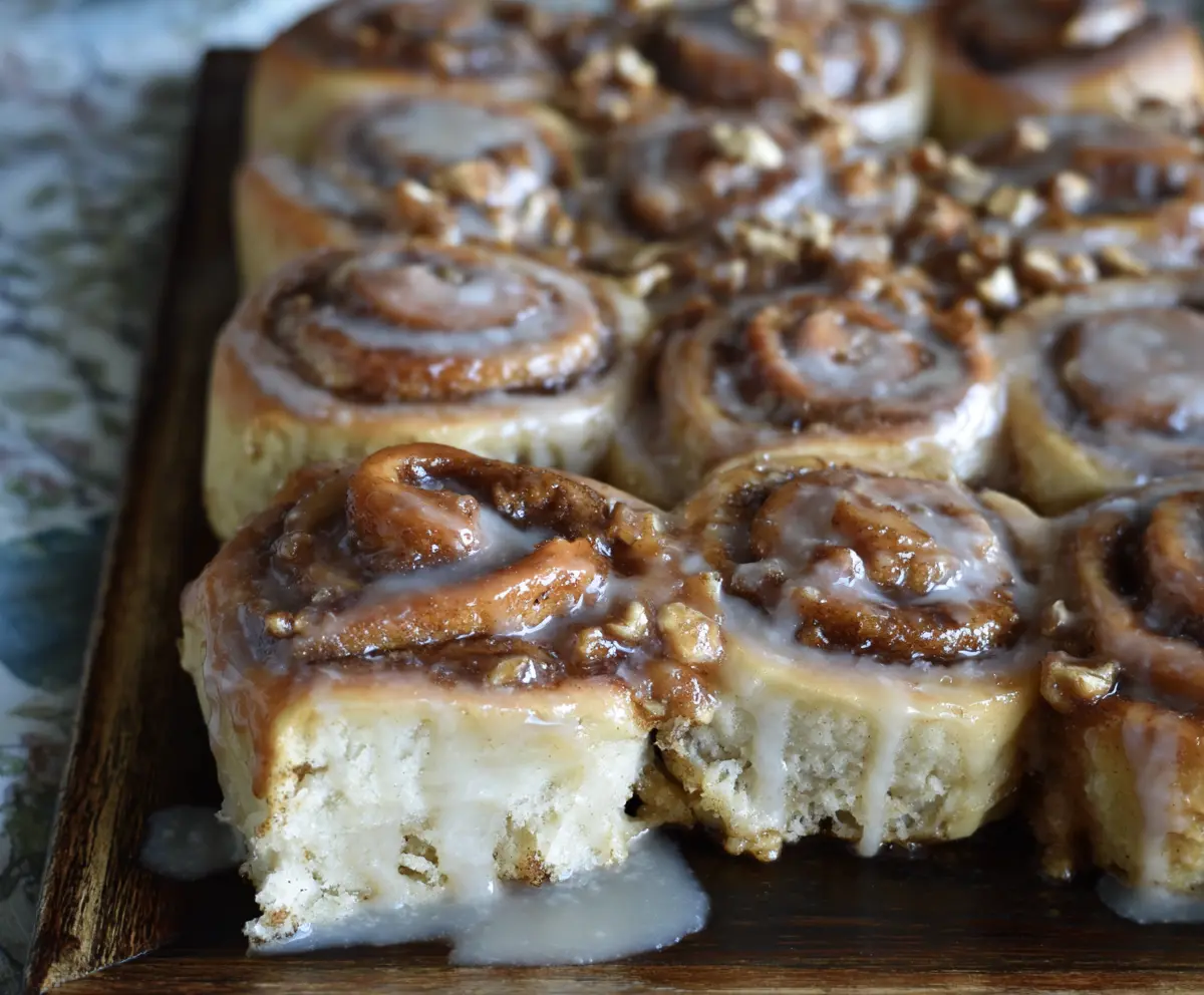 Delicious sourdough apple cider cinnamon rolls topped with icing, perfect for breakfast or dessert.