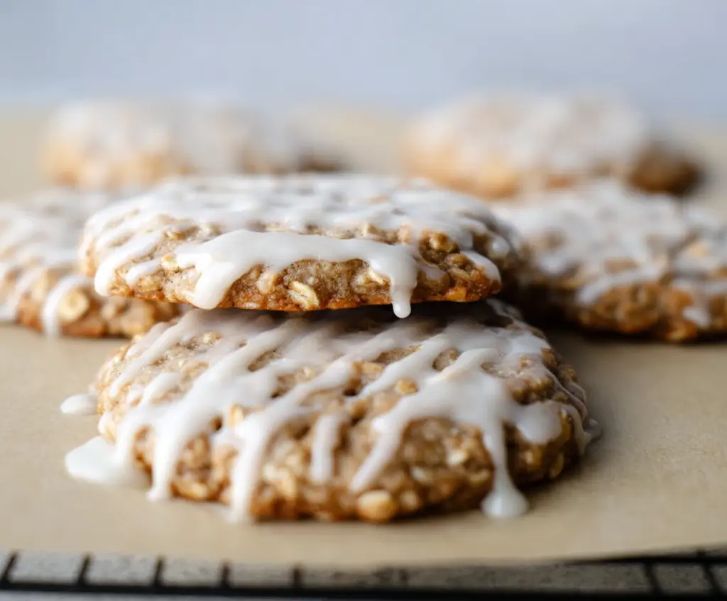 Delicious sourdough discard glazed oatmeal cookies on a plate, showcasing a golden-brown crust and chewy texture.