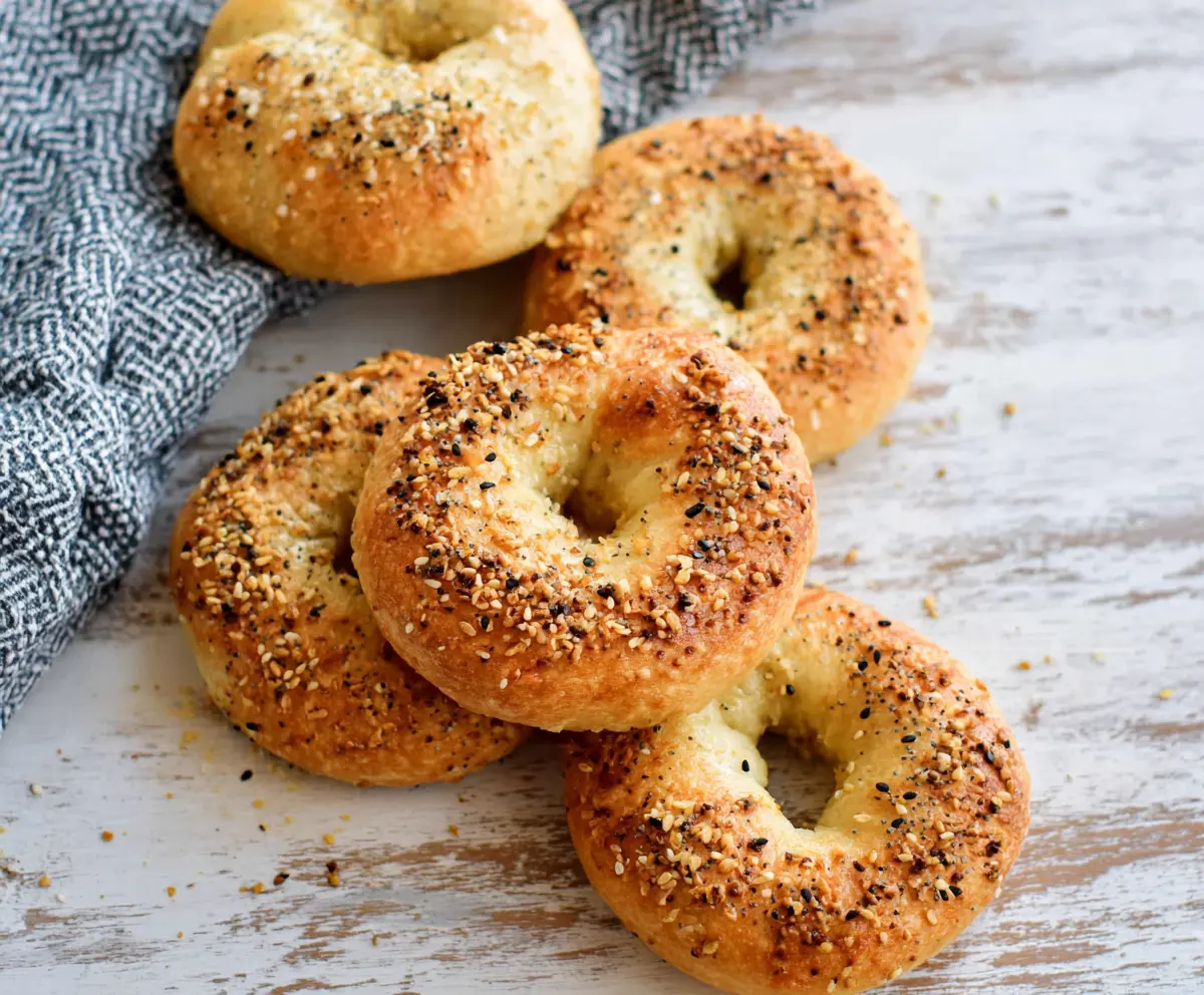 Delicious homemade 3 ingredient air fryer bagels on a baking sheet.