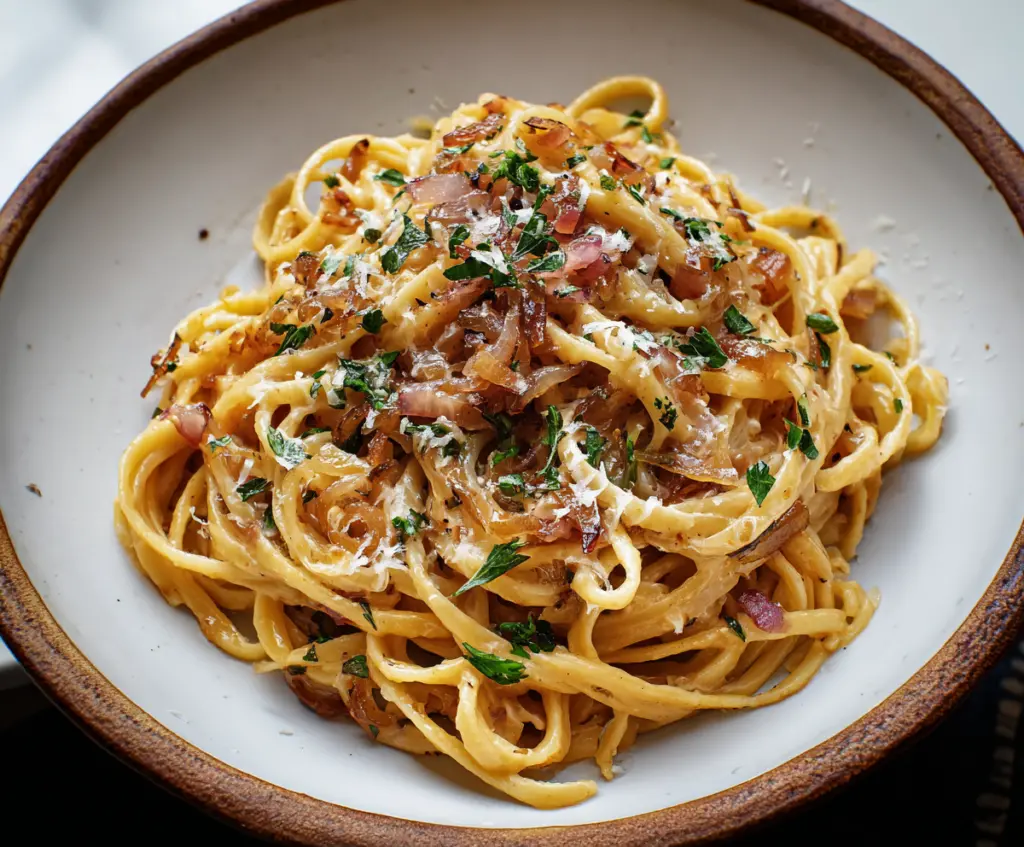 Delicious caramel onion pasta served on a plate, showcasing a creamy, flavorful sauce with caramelized onions.