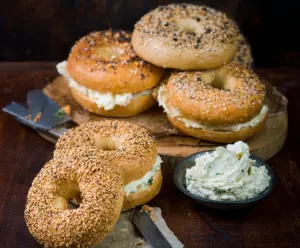 Delicious creamy cheddar bagels fresh out of the oven with melted cheese topping.