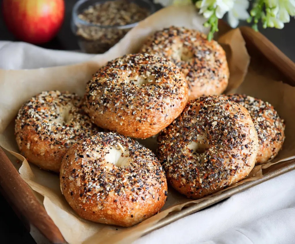 Delicious homemade overnight sourdough bagels resting on a wooden surface.