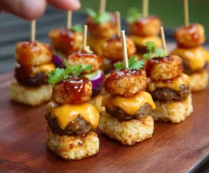 Delicious Tater Tot Mini Cheeseburger Bites served on a plate with fresh toppings.