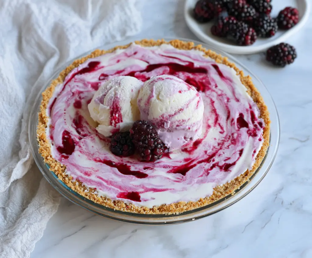 Delicious Blackberry Ice Cream Pie topped with fresh blackberries and mint for a refreshing dessert.