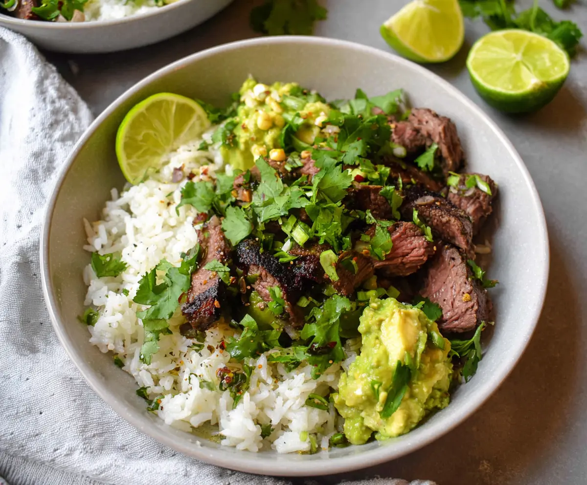 Delicious cilantro lime steak served over rice in a vibrant bowl, perfect for a flavorful meal.