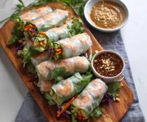 Fresh shrimp rice paper rolls filled with colorful vegetables and herbs, served with dipping sauce.